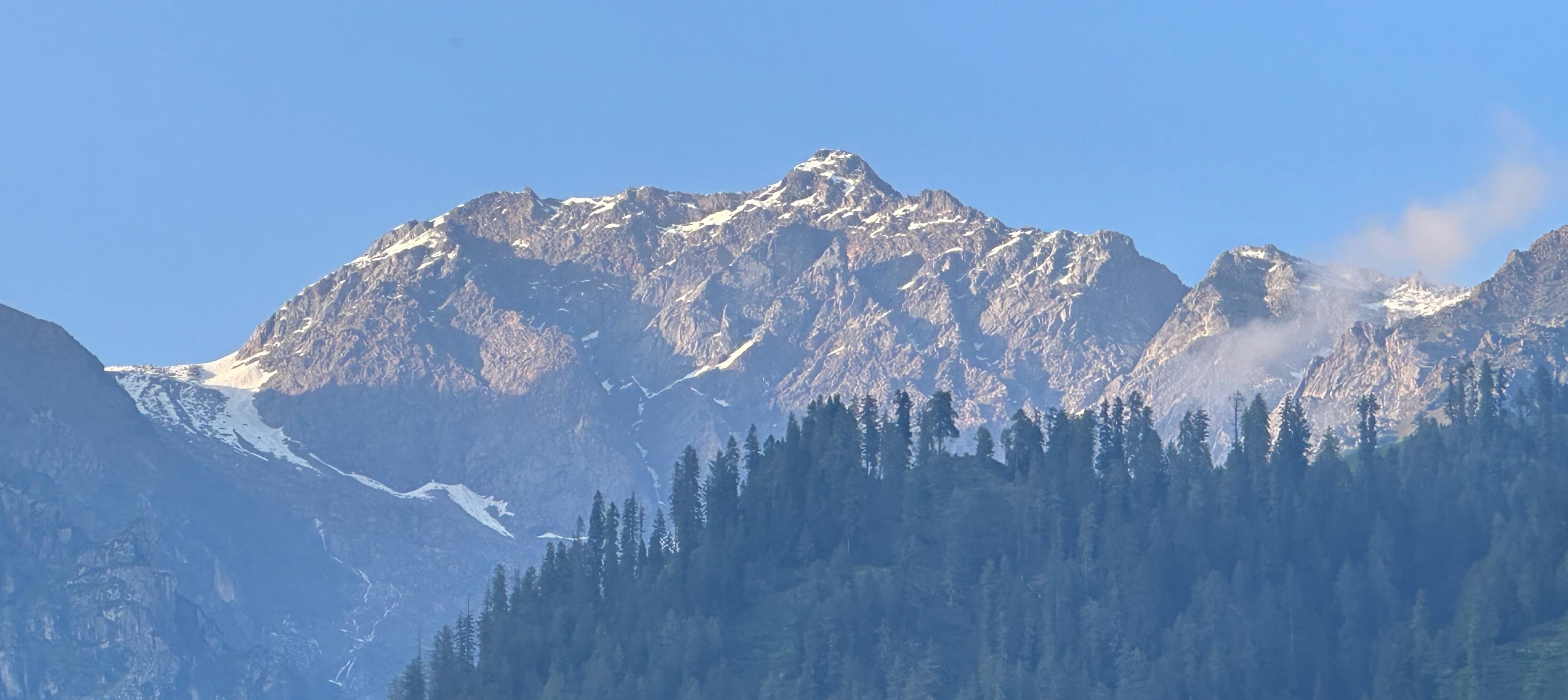 Snow-dusted peaks rising above the pine forests near Shilha