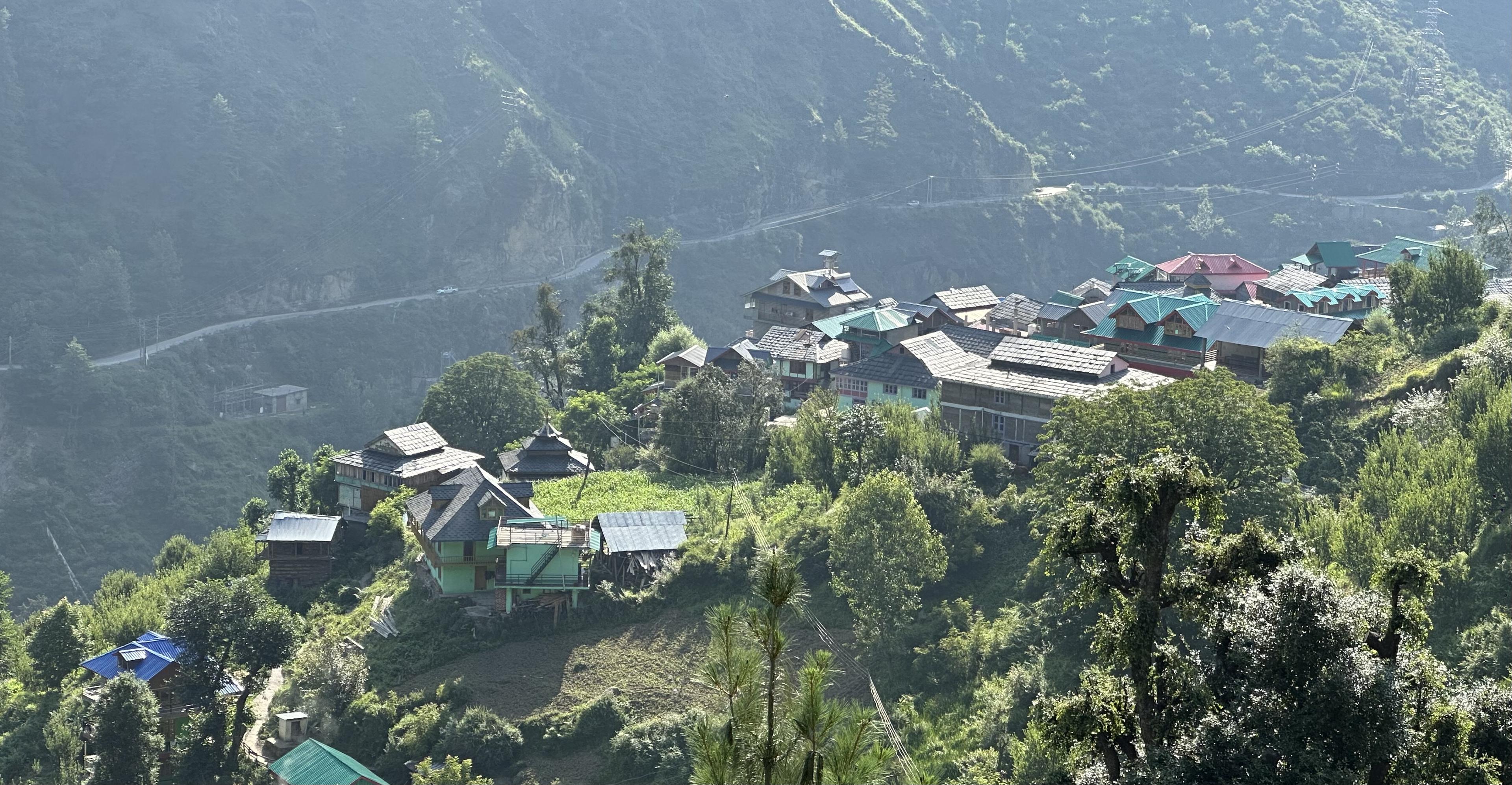 Shilha Village nestled in the green hillside of Parvati Valley