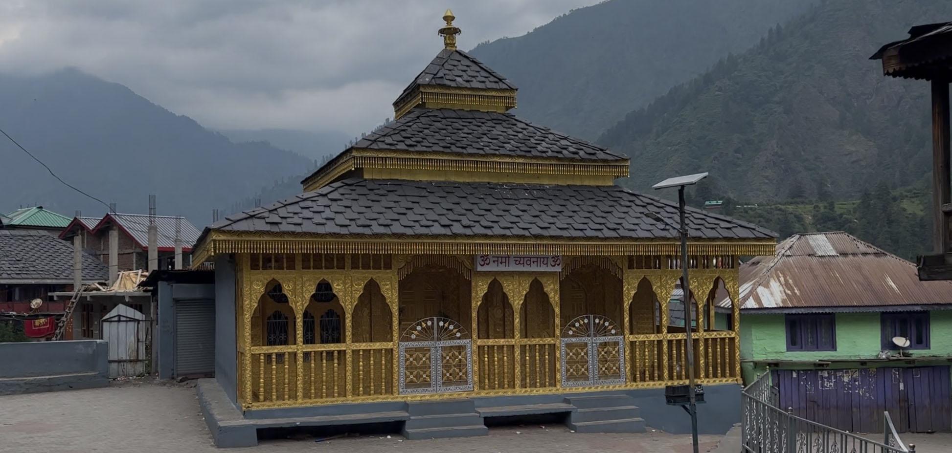 The golden temple in Shilha Village with mountains behind